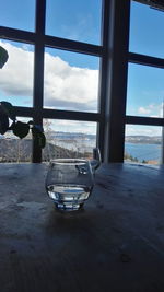 Close-up of table by sea against sky