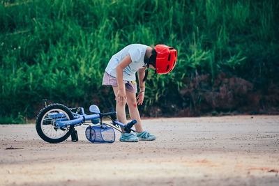 Side view of a man riding bicycle on road