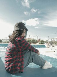 Young woman standing against sky during winter