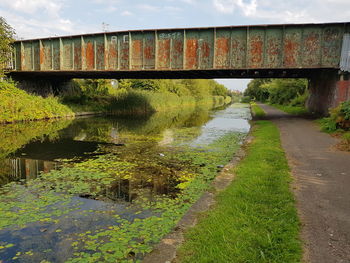 Bridge over canal against sky