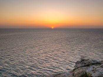 Scenic view of sea against clear sky during sunset