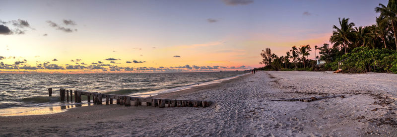 Scenic view of beach against sky during sunset