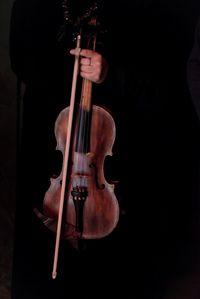 Midsection of man playing guitar