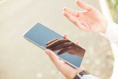 Midsection of woman using mobile phone