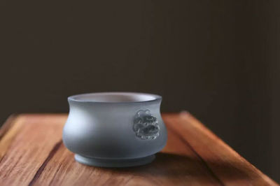 Close-up of tea cup on table against black background