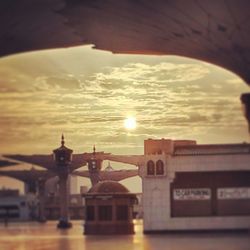 View of built structures against sunset