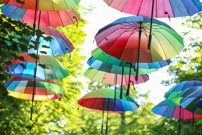 Low angle view of multi colored umbrellas hanging