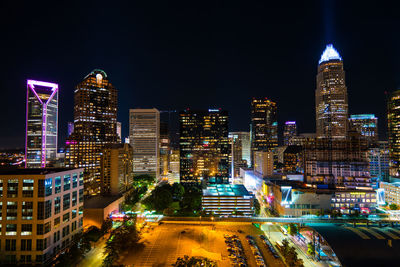 View of skyscrapers lit up at night