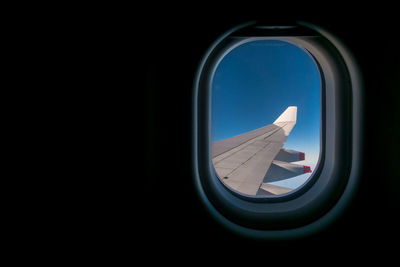 Close-up of airplane wing seen through window