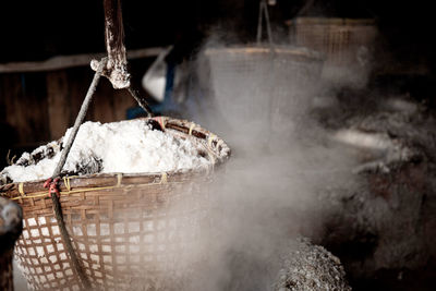 Close-up of food in baskets hanging at darkroom