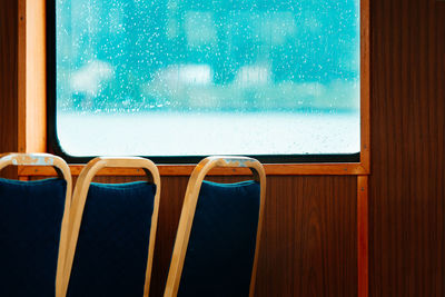 Close-up of chairs and window inside boat