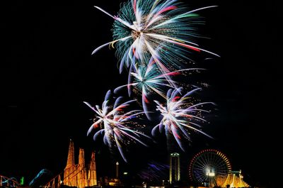 Low angle view of firework display against sky at night