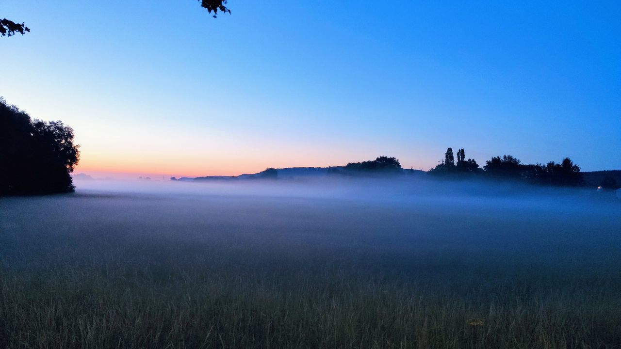 SCENIC VIEW OF FIELD AGAINST SKY AT SUNSET