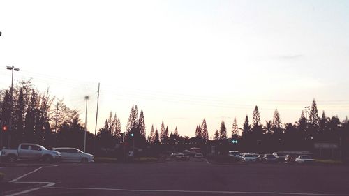 Cars on road at sunset