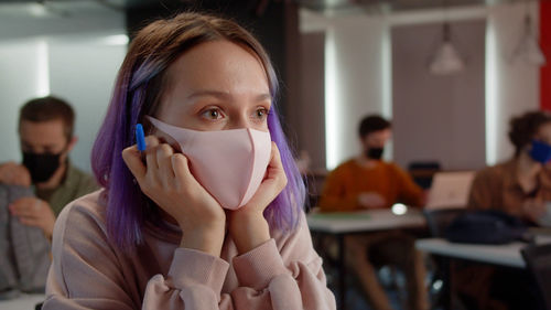 Portrait of young woman wearing mask