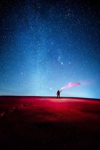 Full length of woman standing on field against sky at night