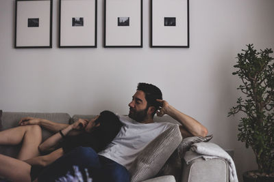 Couple relaxing on sofa at home