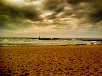 Scenic view of sea against cloudy sky