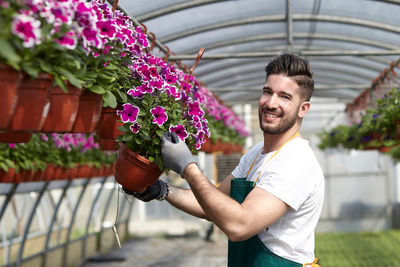 Man holding flower pot on potted plant