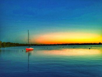 Boats in sea at sunset