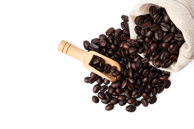 High angle view of coffee beans against white background