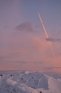 Scenic view of snowcapped mountains against sky during sunset