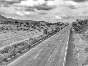 Road by city against sky