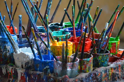 Close-up of paintbrushes in container