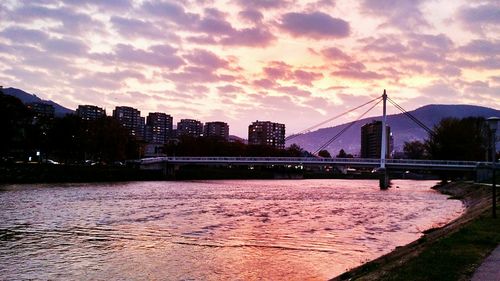 View of bridge over river against cloudy sky