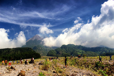 People on mountain against sky