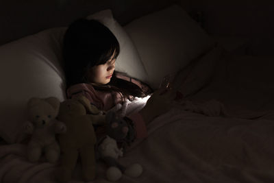 Girl using cell phone in bed