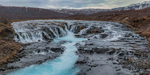 Full frame view of stunning waterfalls with unique blue water colors