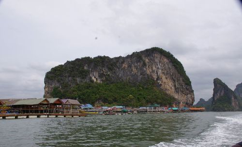 Scenic view of sea and mountains against sky