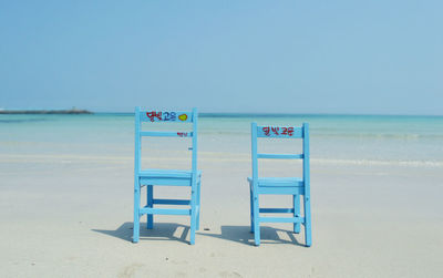 Lifeguard hut on beach against clear sky