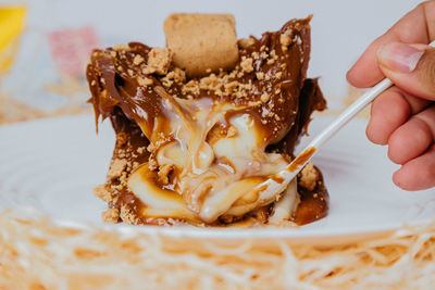 Close-up of hand holding ice cream