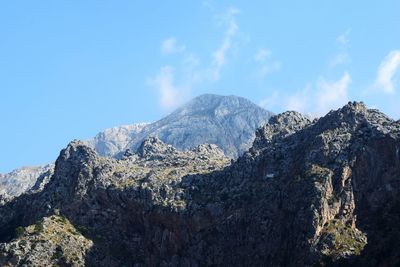 Scenic view of mountains against blue sky