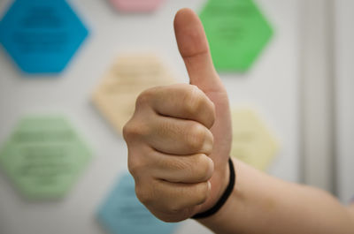 Close-up of cropped hand showing thumbs up