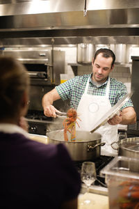 Man preparing lobster at commercial kitchen