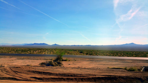 Scenic view of landscape against blue sky