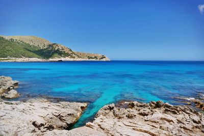 Scenic view of sea against clear blue sky