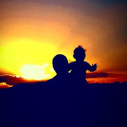 Silhouette men against sky during sunset