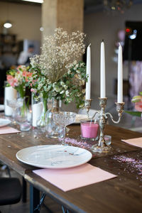 Flower vase on table in cafe