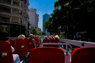 Rear view of people in front of city