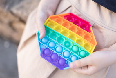 High angle view of woman holding multi colored toy