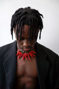 Black man wearing chili necklace portrait