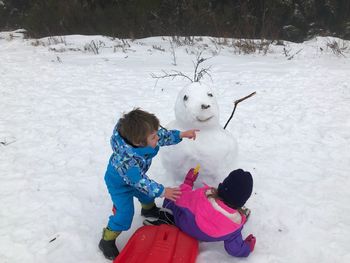 Rear view of girl on snow field during winter