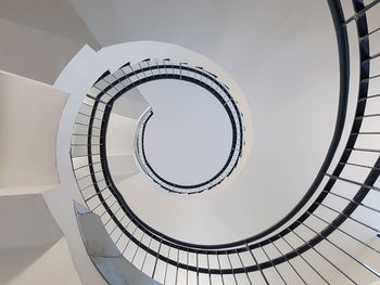 Directly below of spiral staircase in building