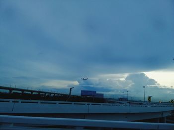 Airplane flying over water against sky