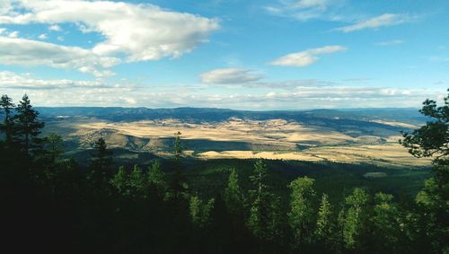 Scenic view of mountains against cloudy sky