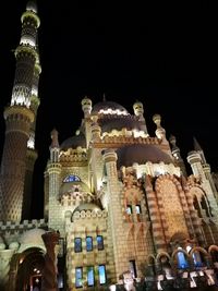 Low angle view of illuminated cathedral against sky at night